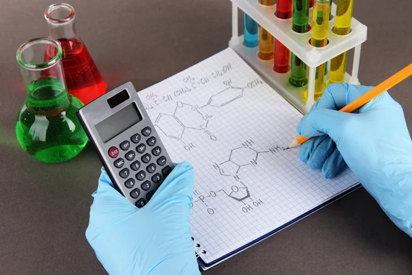 Hand scientist writing formulas — Stock Photo, Image