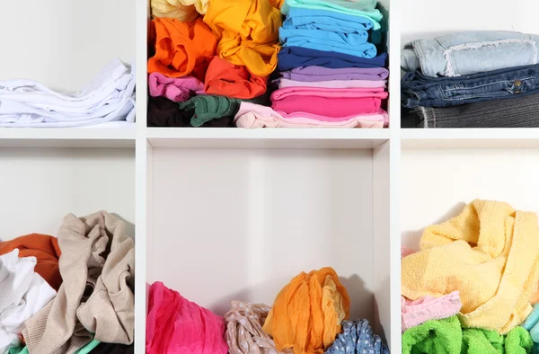 Clothing scattered on shelves — Stock Photo, Image