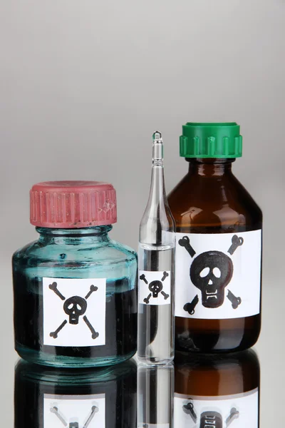 Deadly poison in bottles on grey background — Stock Photo, Image