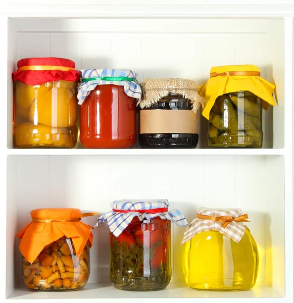 Homemade preserves on beautiful white shelves — Stock Photo, Image