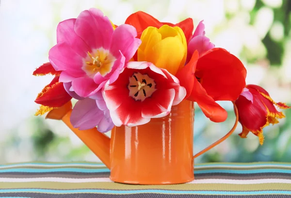 Beautiful tulips in bouquet on table on bright background — Stock Photo, Image