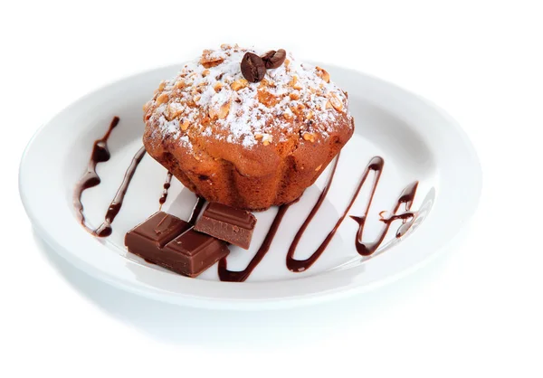 Gâteau au muffin savoureux avec sucre en poudre sur assiette, isolé sur blanc — Photo