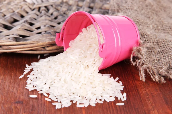 Overturned bucket with grains on wooden background — Stock Photo, Image