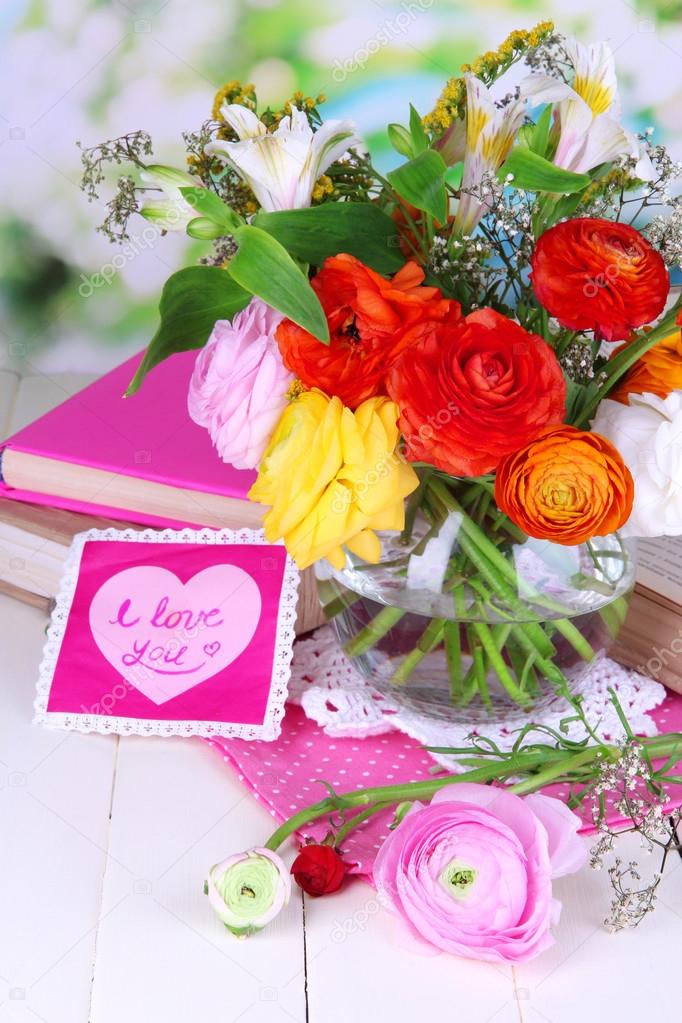 Scenic still life of flowers buttercups on wooden table on natural