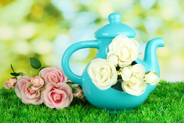 Pot with flowers on the grass on the nature background — Stock Photo, Image