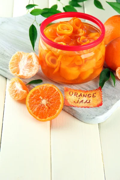Mermelada de naranja con ralladura y mandarinas, sobre mesa de madera blanca —  Fotos de Stock