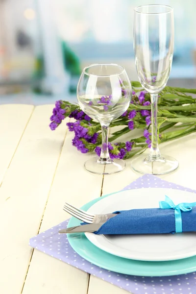 Table serving on a wooden background on the background of the room — Stock Photo, Image