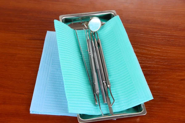 Dentist tools on wooden table — Stock Photo, Image