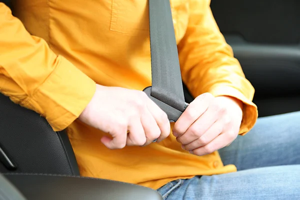 Woman attaching seat belt in the car, close up — Stok fotoğraf