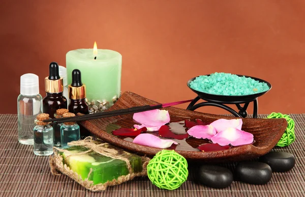 Spa composition with aroma oils on brown background — Stock Photo, Image