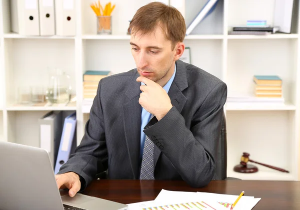 Young businessman in office at his workplace — Stock Photo, Image