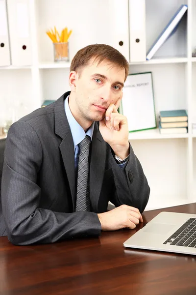 Young businessman in office at his workplace — Stock Photo, Image