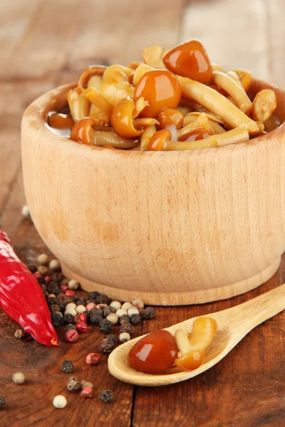 Mushrooms in bowl, on wooden background — Stock Photo, Image