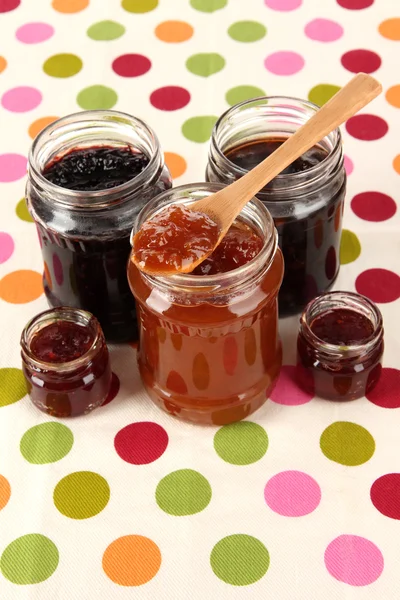 Tasty jam in banks on table — Stock Photo, Image