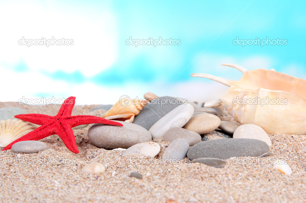 Sea stones on sand on bright background