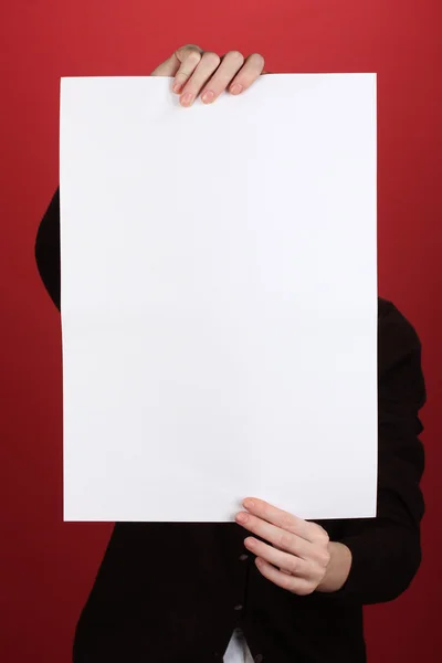 Woman holding blank sign in front her face, on color background — Stock Photo, Image