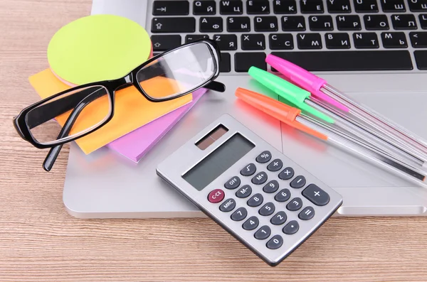 Laptop with stationery on table — Stock Photo, Image