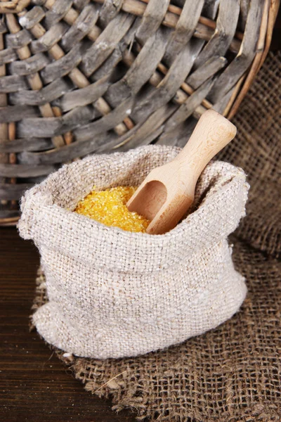 Grains in sack on wooden background — Stock Photo, Image