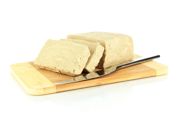 Tasty halva on cutting board isolated on white — Stock Photo, Image