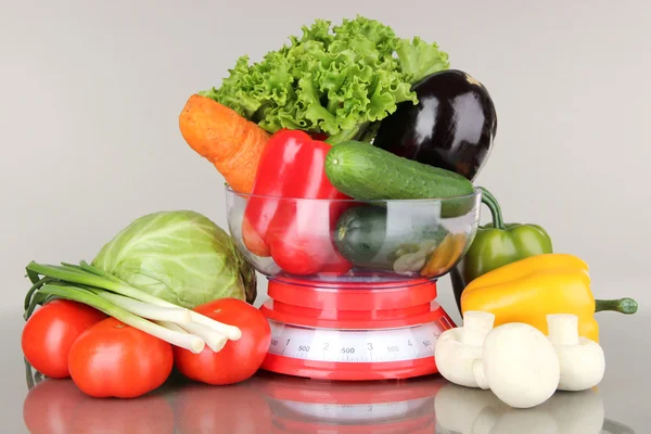 Fresh vegetables in scales on gray background — Stock Photo, Image