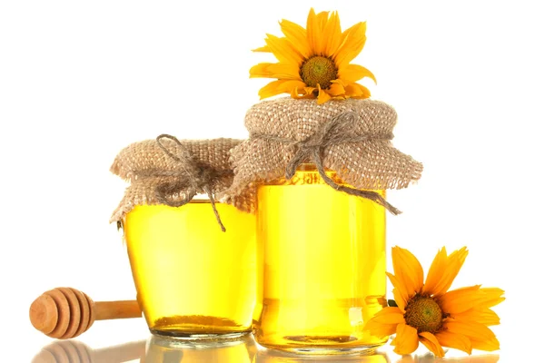 Sweet honey in jars with wooden drizzler and flowers isolated on white — Stock Photo, Image