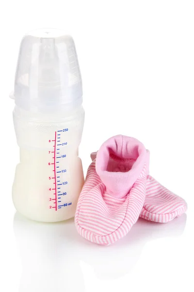 Bottle for milk formula with booties isolated on white — Stock Photo, Image