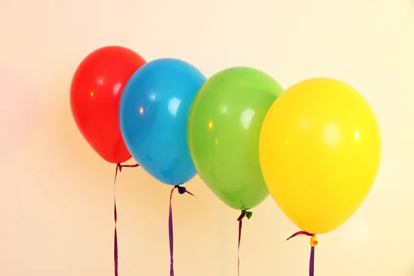Four bright balloons on light background — Stock Photo, Image