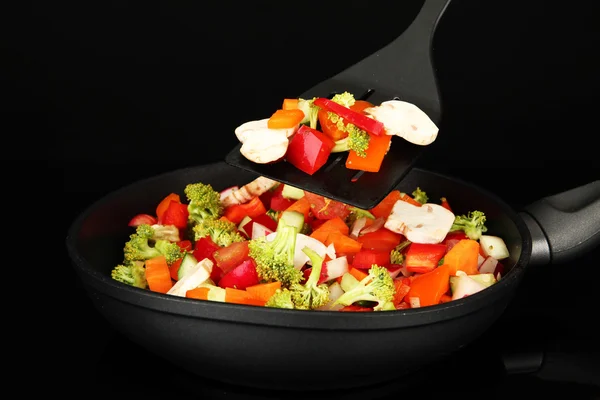 Vegetable ragout in pan, isolated on black — Stock Photo, Image