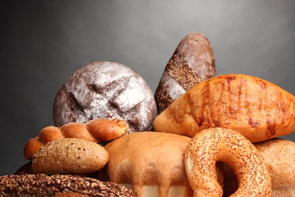 Delicious bread on wooden table on gray background — Stock Photo, Image