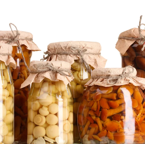 Delicious marinated mushrooms in the glass jars isolated on white — Stock Photo, Image