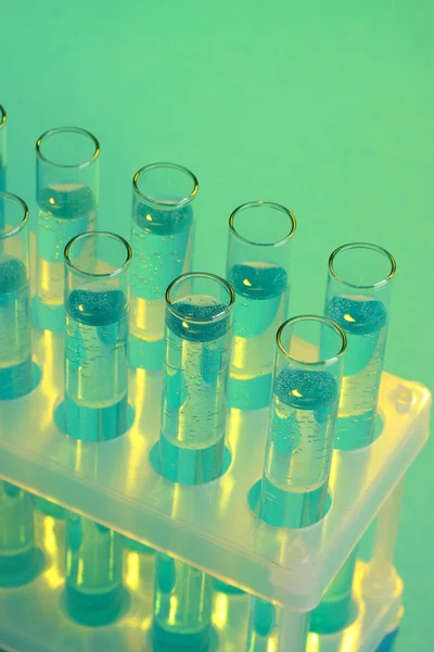 Test-tubes with liquid on blue background — Stock Photo, Image