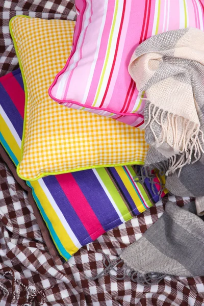 Three various pillows on plaid — Stock Photo, Image