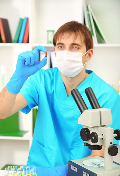 Assayer during research on room background — Stock Photo, Image