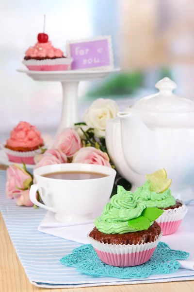Beautiful cupcakes on dining table on room background — Stock Photo, Image