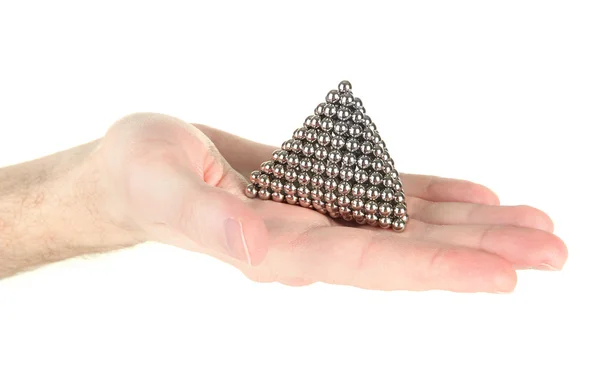 Pyramid of metal balls for neocube (toy) on man hand, isolated on white — Stock Photo, Image