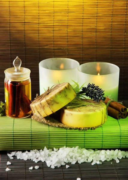 Hand made soap and candles on bamboo mat background — Stock Photo, Image