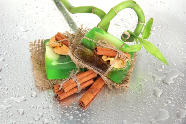 Hand-made soap and bamboo with drops, close up — Stock Photo, Image