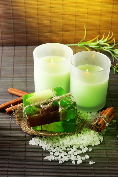 Hand made soap and candles on bamboo mat background — Stock Photo, Image