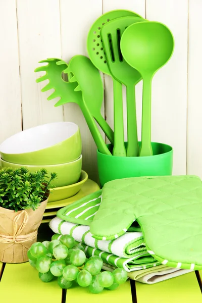 Kitchen settings: utensil, potholders, towels and else on wooden table — Stock Photo, Image