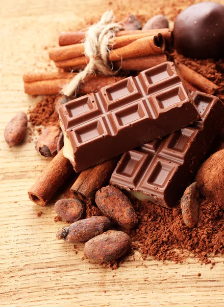 Skład czekolady słodycze, kakao i przyprawy na drewniane tła — Zdjęcie stockowe