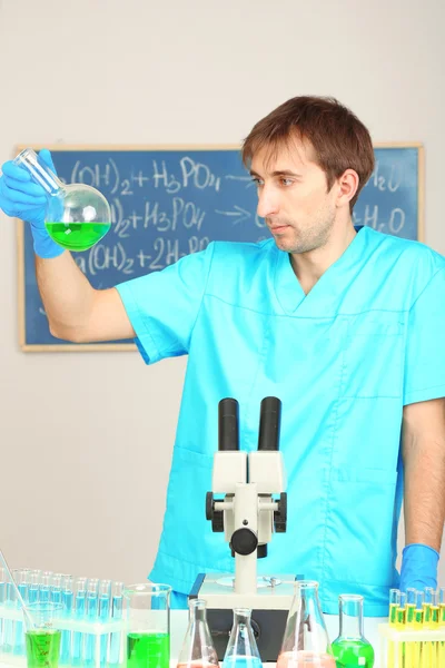 Assayer during research on room background — Stock Photo, Image