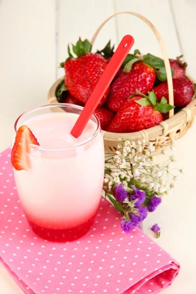 Delicious strawberry yogurt in glass on wooden table close-up — Stock Photo, Image