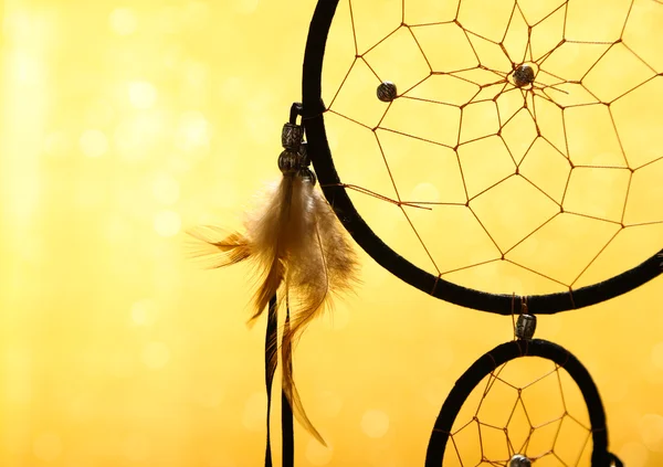 Beautiful dream catcher on yellow background — Stock Photo, Image