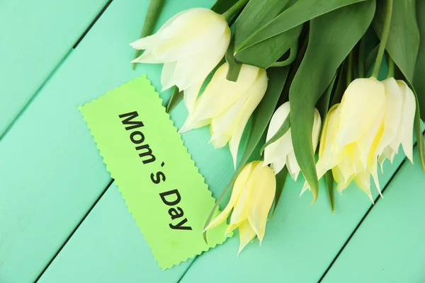 Beautiful white tulips on color wooden background — Stock Photo, Image