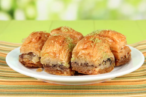 Sweet baklava on plate on table on bright background — Stock Photo, Image