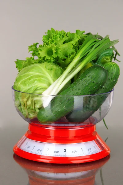 Fresh vegetables in scales on gray background — Stock Photo, Image