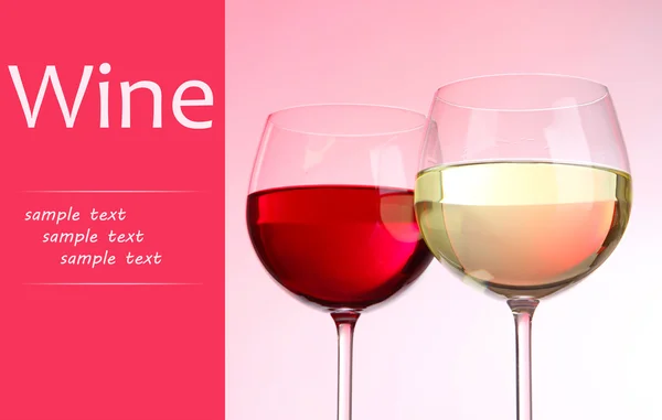 Two glasses with red and white wine on pink background — Stock Photo, Image