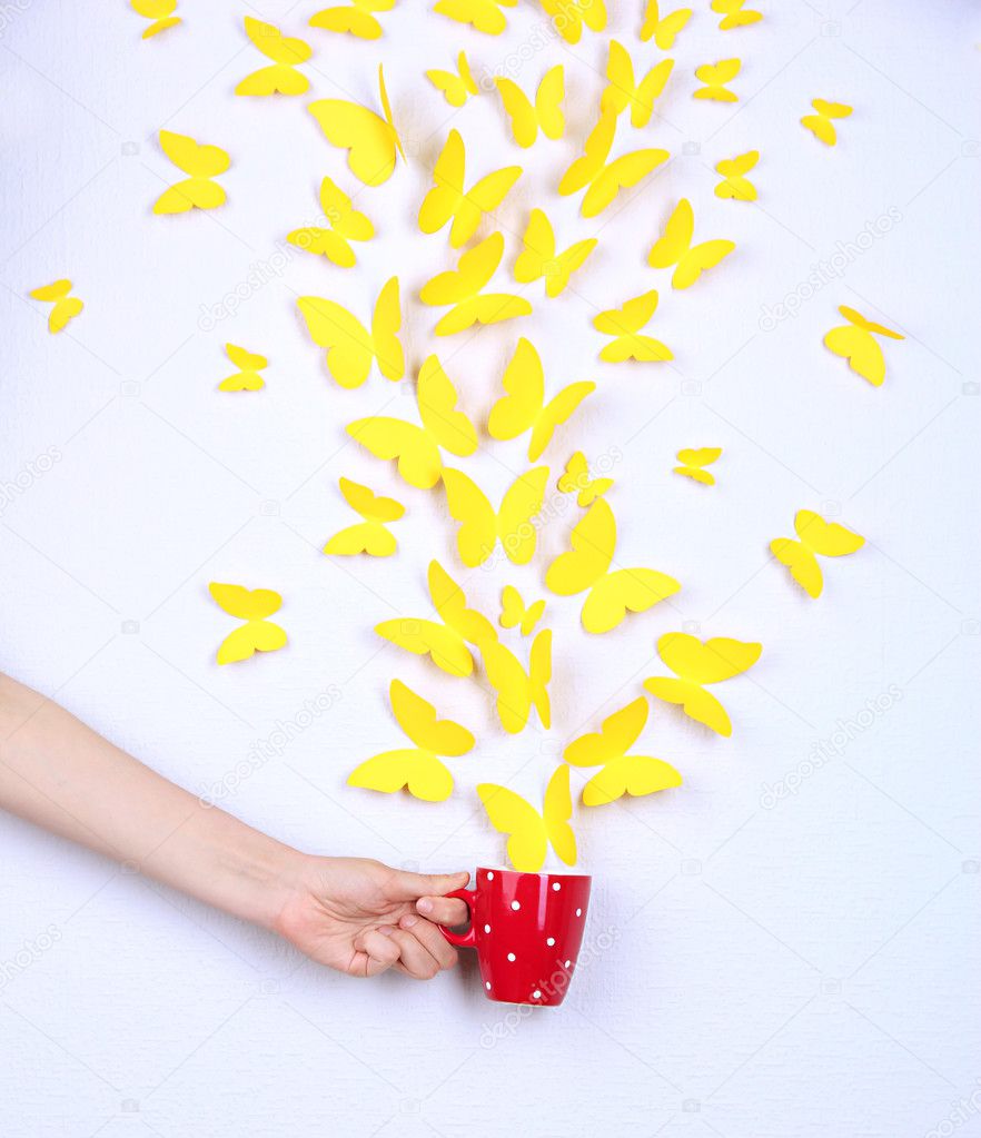 Paper yellow butterflies fly out of cup