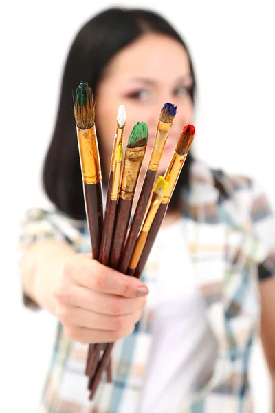 Beautiful young woman painter with brushes, isolated on white — Stock Photo, Image