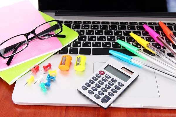 Laptop with stationery on table — Stock Photo, Image